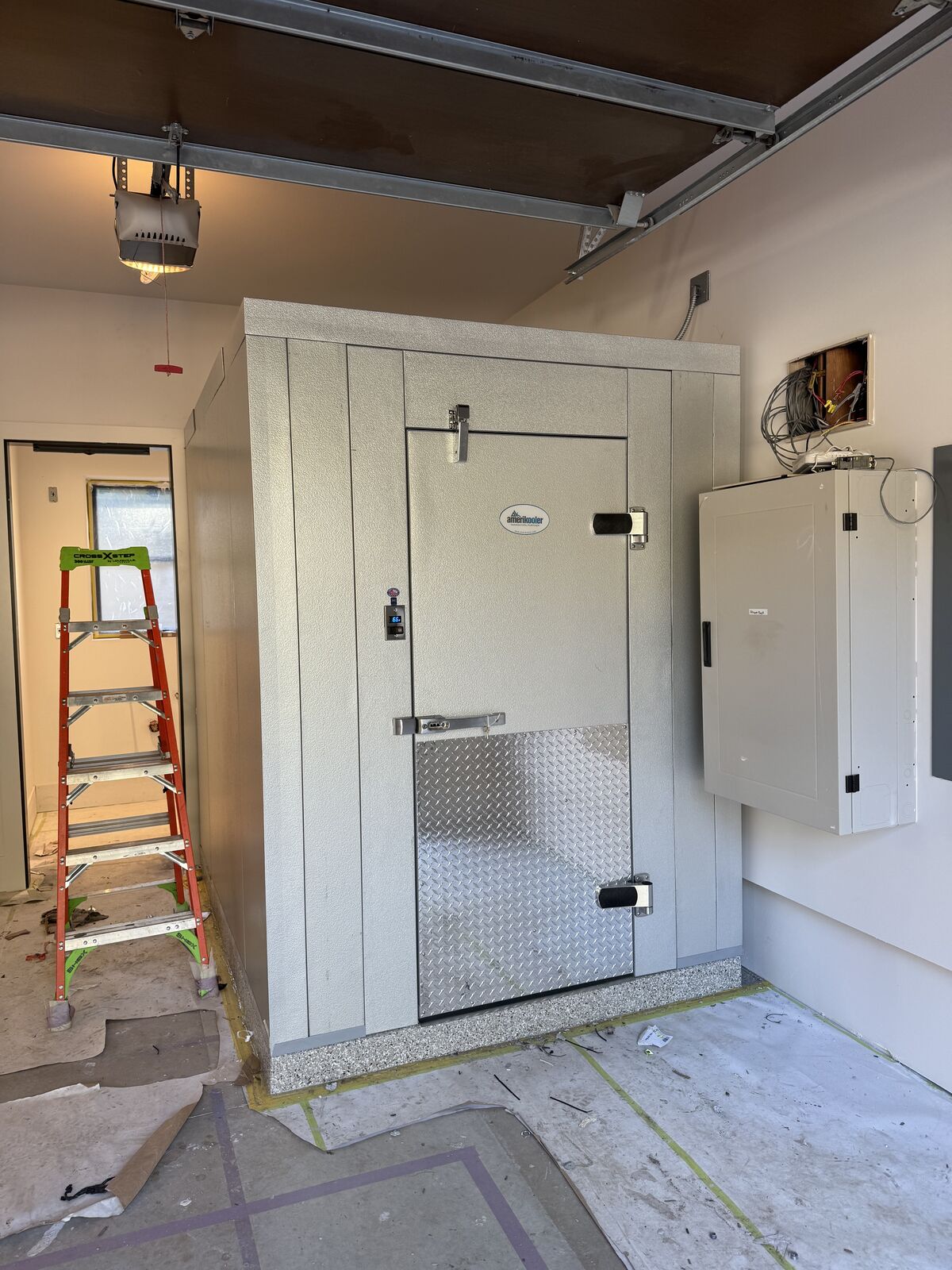 Custom walk-in cooler built by Carney Refrigeration Inc. in a private residence garage